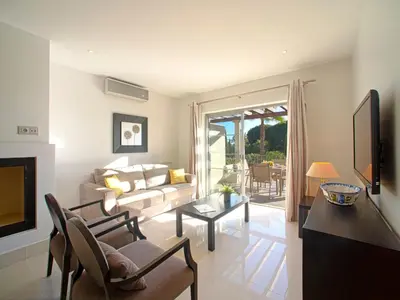 a living room with a table and a dining room at Apartment Pine Hills Rubi by Interhome in Vilamoura