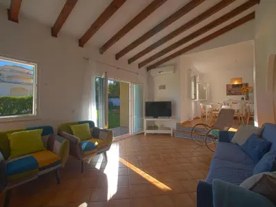 a living room with blue couches and a tv at Villa Mariana by Interhome in Galé