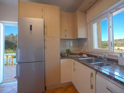 a kitchen with a white refrigerator and a sink at Villa Mariana by Interhome in Galé