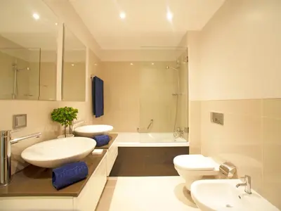 two beds with blue pillows in a room with a window at Apartment Pine Hills Ametista by Interhome in Vilamoura