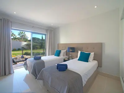 two beds in a room with a window at Apartment Pine Hills Pérola by Interhome in Vilamoura