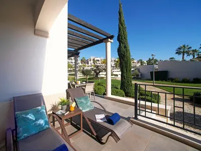 a dining room with a black table and chairs at Apartment Pine Hills Pérola by Interhome in Vilamoura