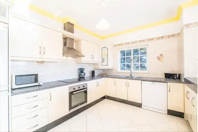 a large kitchen with white cabinets and appliances at Villa Mar & Sol by Algarve Vacation in Albufeira
