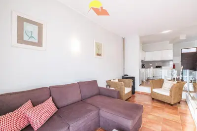 a living room with a brown couch and chairs at #099 T1 Caliços by Home Holidays in Albufeira
