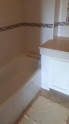 a white bath tub in a room with a rug at 1-Bed - Sleeps 4 - Free Parking & Balcony in Albufeira