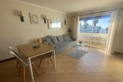 a living room with a couch and a table at 1-Bed - Sleeps 4 - Free Parking & Balcony in Albufeira