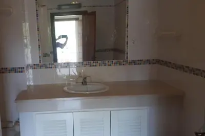 a bathroom with a sink and a mirror at 1-Bed - Sleeps 4 - Free Parking & Balcony in Albufeira