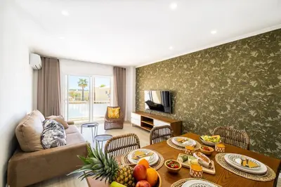 a living room with a table with food on it at Benjamin Apartment in Guia