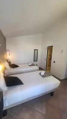 a hotel room with two beds in it at Oura Villa V2 Jacarandá in Albufeira