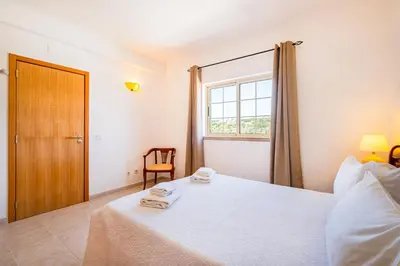 a bedroom with a bed with two towels on it at Villa Duarte in Albufeira