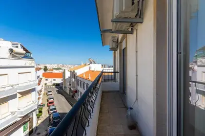 a balcony of a building with a view of a city at T3 Apartamento do Tenis in Albufeira