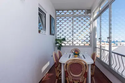 a balcony with a table and chairs and a window at T3 Apartamento do Tenis in Albufeira