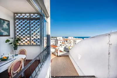 a balcony with a table and a view of the ocean at T3 Apartamento do Tenis in Albufeira