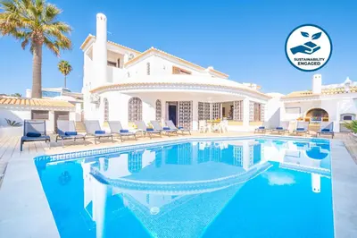 a villa with a swimming pool in front of a house at Villa Molucas by Algarve Vacation in Albufeira