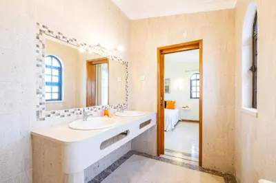 a bathroom with two sinks and a large mirror at Villa Molucas by Algarve Vacation in Albufeira