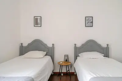 two beds sitting next to each other in a bedroom at Down Town Beach House in Albufeira