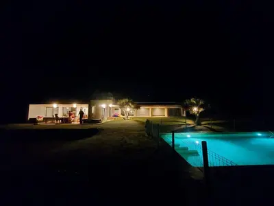 a house with a swimming pool at night at Casa do Cabeçudo in Faro