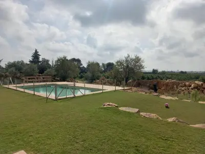 a house with a swimming pool in front of a yard at Casa do Cabeçudo in Faro