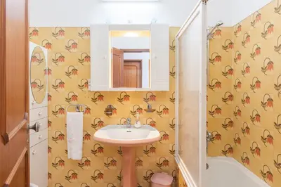 a bathroom with a sink and a mirror at OLIVE - Quarteira in Quarteira