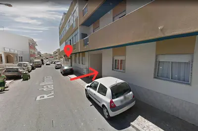 a white car parked in front of a building at OLIVE - Quarteira in Quarteira