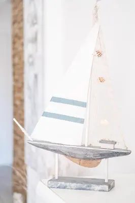 a model boat on a shelf with a flag at Beautifull CentralApart W/pool in Albufeira