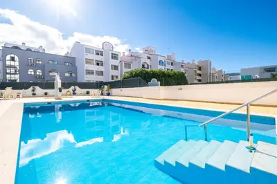 a large swimming pool in front of a building at Beautifull CentralApart W/pool in Albufeira