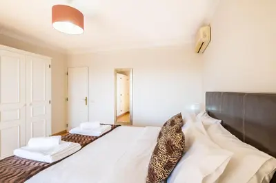 a bedroom with a bed with a leopard print tie on it at Villa Estrelícia - Pool - Free wi-fi - New in Booking in Loulé