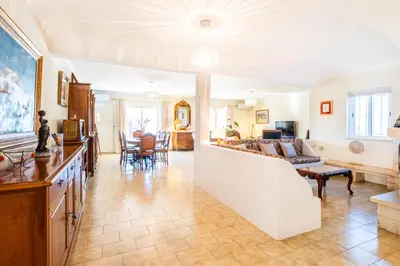 a living room with a couch and a table at Villa Estrelícia - Pool - Free wi-fi - New in Booking in Loulé