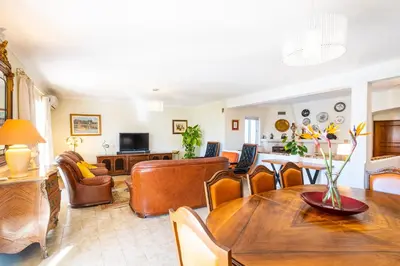 a living room with a table and a couch at Villa Estrelícia - Pool - Free wi-fi - New in Booking in Loulé