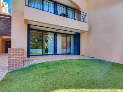 a house with a large yard in front of it at AL - Apartamento Vila Sol F5 AO in Vilamoura