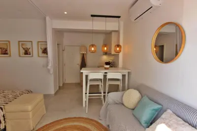 a living room with a couch and a table at Quarteira Mar - Beach Front in Quarteira