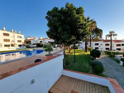 a white bedroom with a bed and a window at #109 Zélio House by Home Holidays in Albufeira