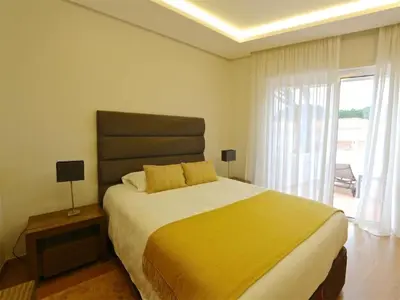 a bedroom with a large bed with a yellow blanket at Lovely Vilamoura Villa 4 Bedrooms Villa Pinhal Short Drive To Marina in Quarteira
