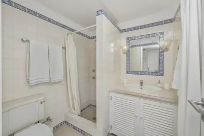 a bathroom with a sink and a toilet and a mirror at Villa Casa do Amendoal by Villa Plus in Albufeira