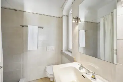 a bathroom with a sink and a toilet and a mirror at Villa Casa do Amendoal by Villa Plus in Albufeira