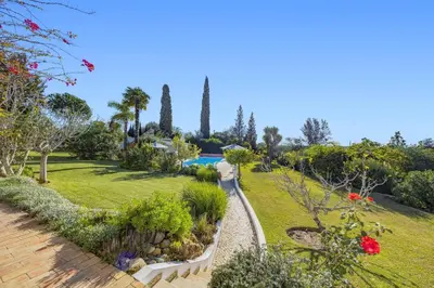 a view of a garden with a swimming pool at Villa Casa do Amendoal by Villa Plus in Albufeira