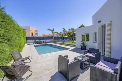 a patio with chairs and a swimming pool at Villa Casa Morim by Villa Plus in Olhos de Água