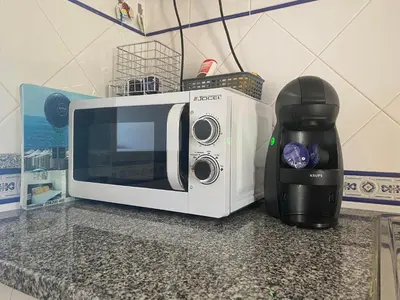 a white microwave sitting on a counter next to a blender at Sunset Haven in Albufeira - Short walk to Oldtown in Albufeira