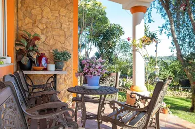 an outdoor patio with chairs and a table with flowers at Villa V4 Máximo in Albufeira