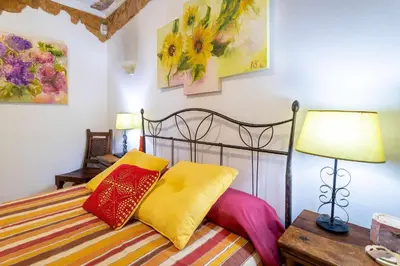 a bedroom with a bed with colorful pillows on it at Villa V4 Máximo in Albufeira