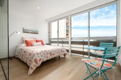 a bedroom with a bed and a table and chairs at Apartamento Algarve, located center of Vilamoura in Quarteira