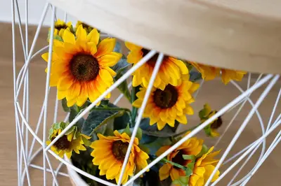 a bunch of yellow sunflowers in a vase on a table at Apartamento Algarve, located center of Vilamoura in Quarteira