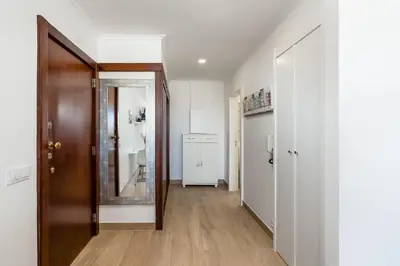 an empty hallway with a mirror and a door at Apartamento Algarve, located center of Vilamoura in Quarteira