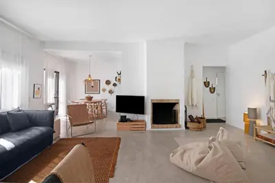 a living room with a couch and a tv at Balaia 9 in Olhos de Água