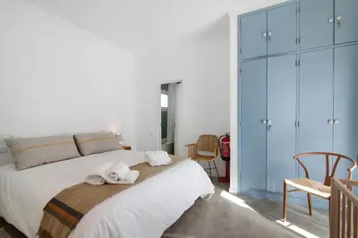 a bedroom with a large bed with towels on it at Balaia 9 in Olhos de Água