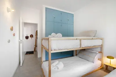 a bedroom with a large bed with two towels on it at Balaia 9 in Olhos de Água