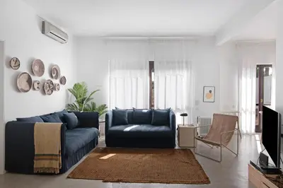 a living room with a blue couch and a chair at Balaia 9 in Olhos de Água
