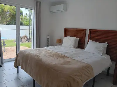 a bedroom with a large bed with a large window at Casa Francisco : Family Villa with private pool. Near to beach in Albufeira