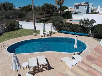 a swimming pool with lounge chairs and a swimming pool at Casa Francisco : Family Villa with private pool. Near to beach in Albufeira
