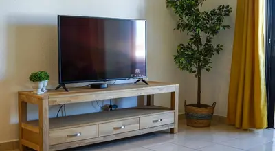 a living room with a couch and a tv at Apartment OuraVale in Albufeira